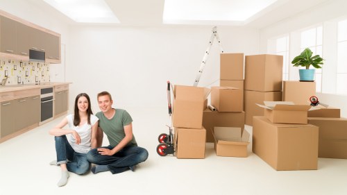 Packed moving boxes and furniture ready for Acton removals