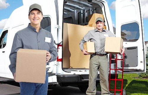 Acton packing team organizing moving boxes and supplies