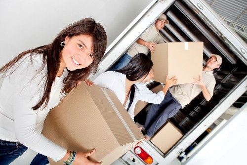 Customer placing packed belongings into a storage unit
